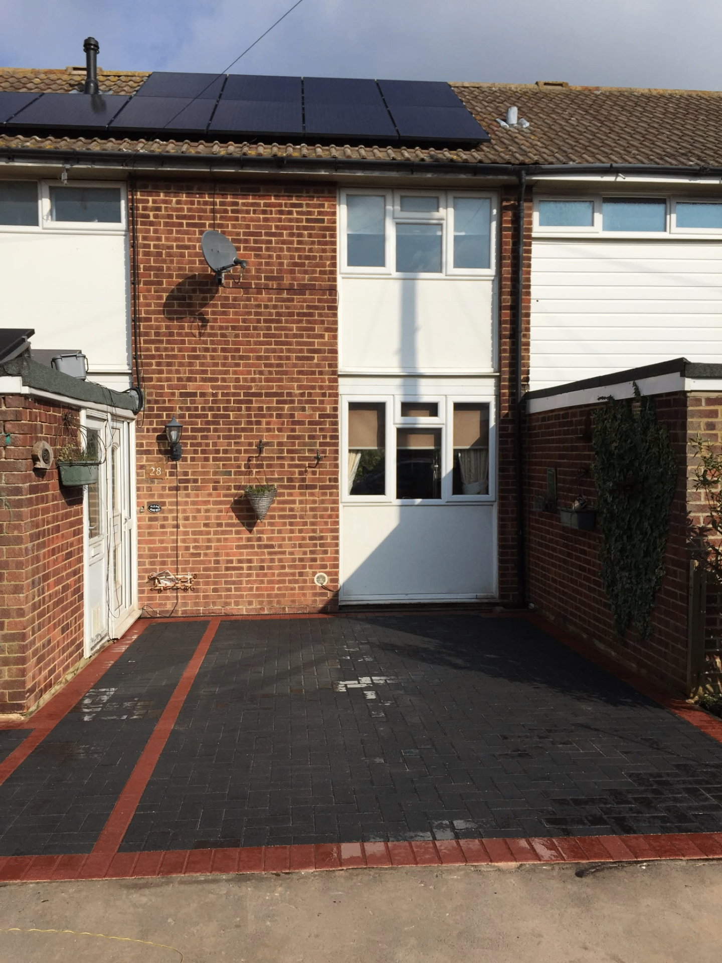 Block paving driveway with red brick border and charcoal herringbone pattern
